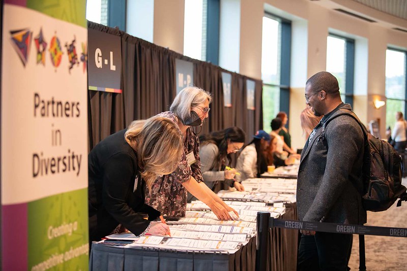 People gathering at a table at the Equity Summit