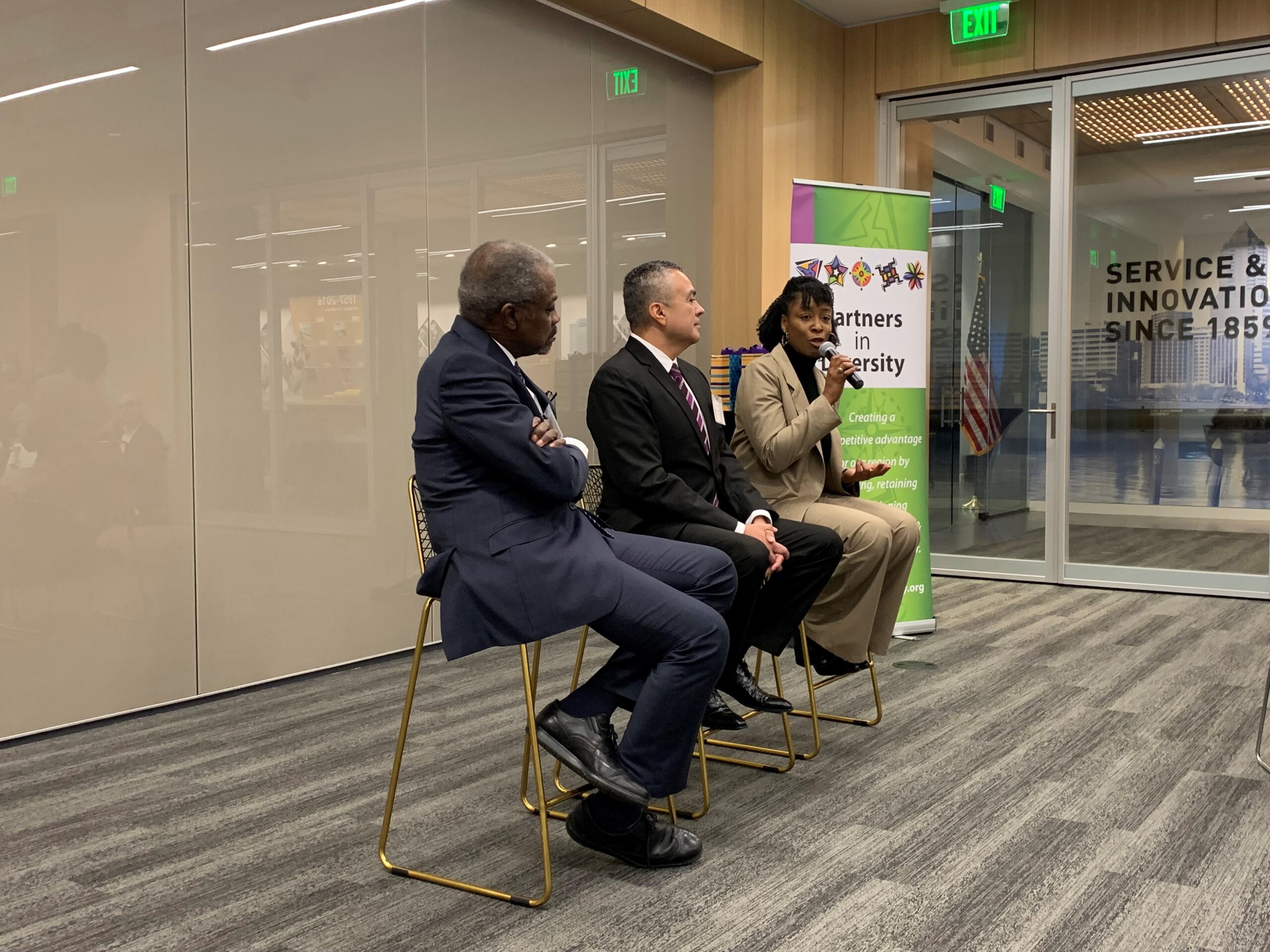 three people speaking at a CEO forum
